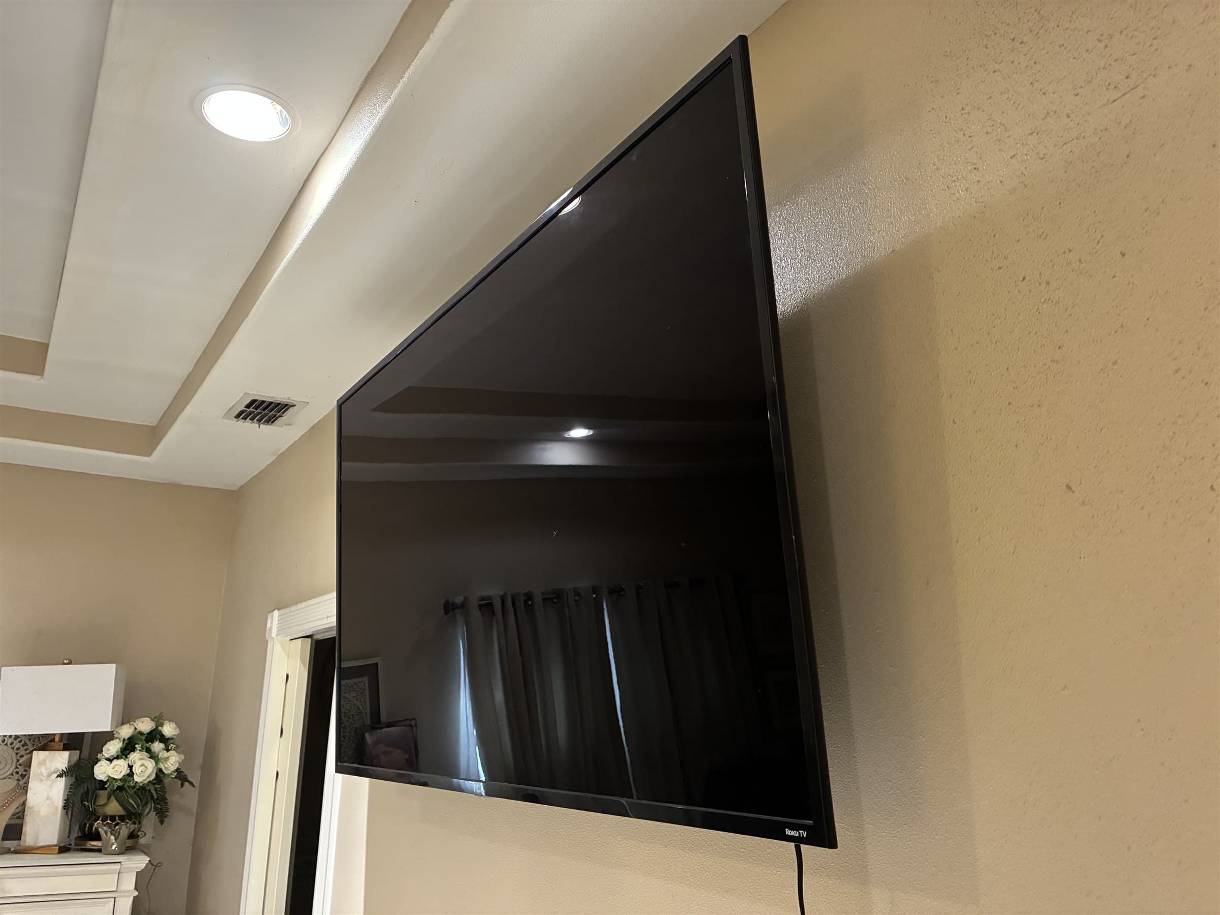 Side profile of full-motion TV wall mount installation